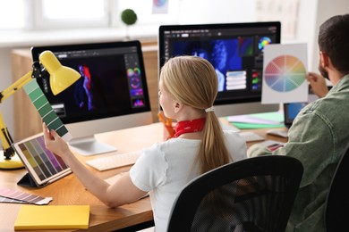 Designers working together at table in office