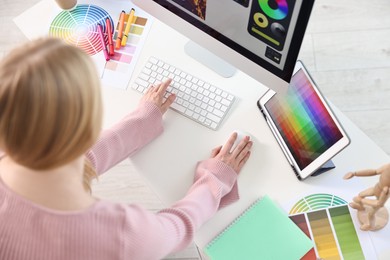 Photo of Designer working at table in office, above view