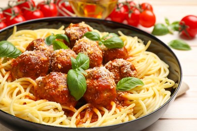 Delicious pasta with meatballs on wooden table, closeup