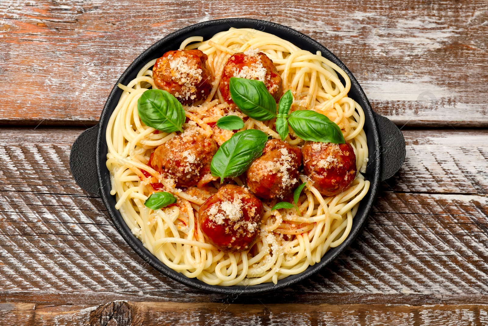 Photo of Delicious pasta with meatballs on wooden table, top view