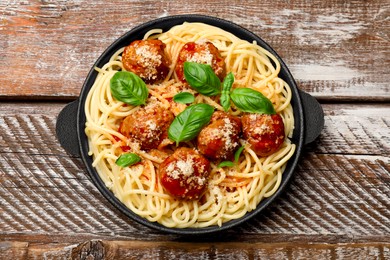 Photo of Delicious pasta with meatballs on wooden table, top view