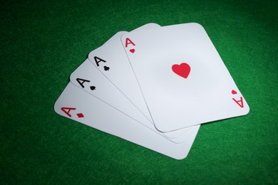 Photo of Poker game. Playing cards on green table