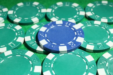 Photo of Poker chips on green table, closeup view