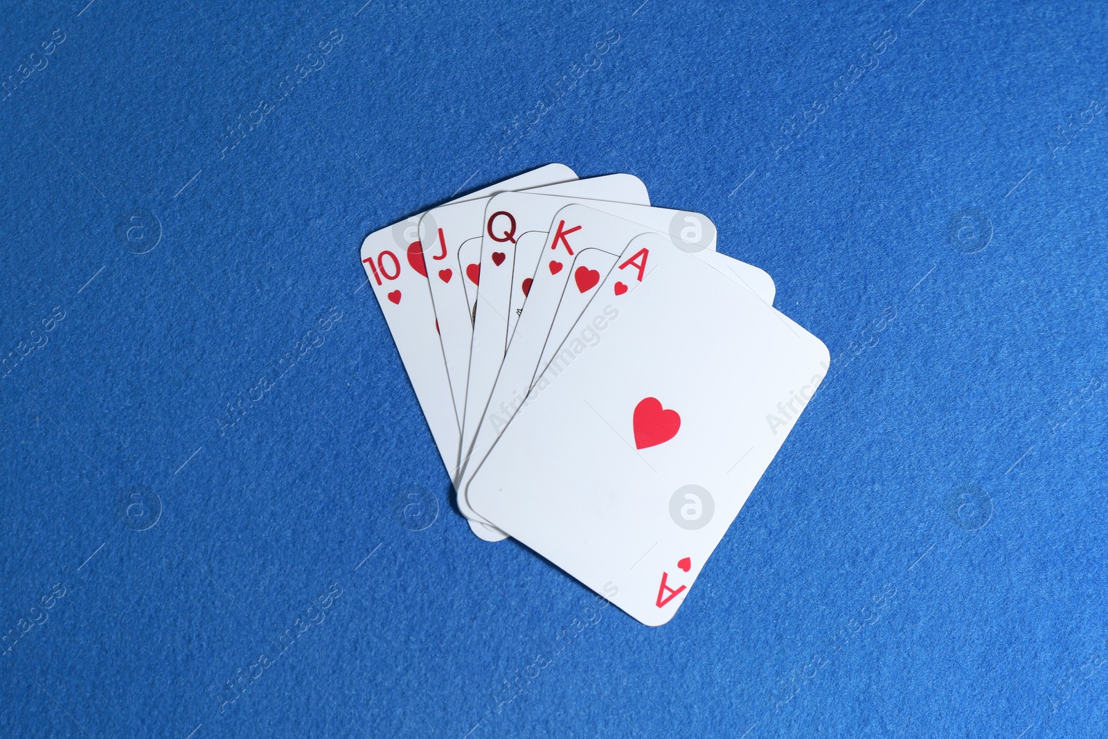 Photo of Poker game. Playing cards on blue table, top view