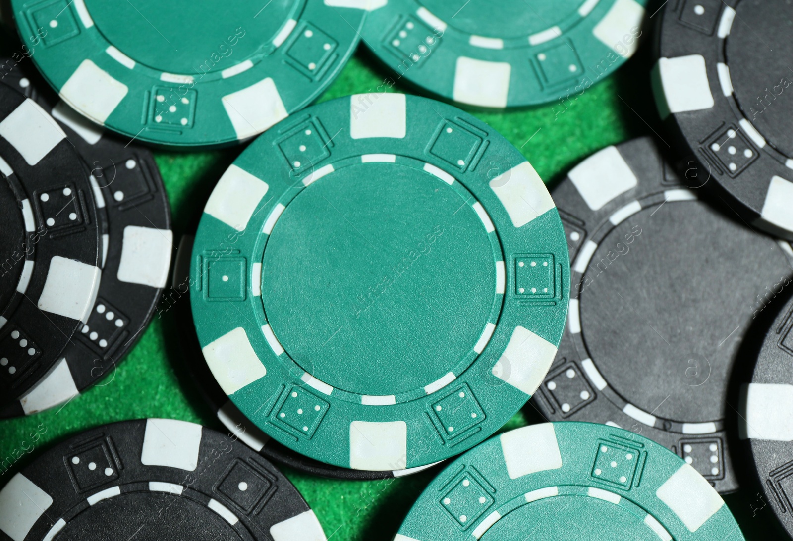 Photo of Poker game. Casino chips on green table, top view