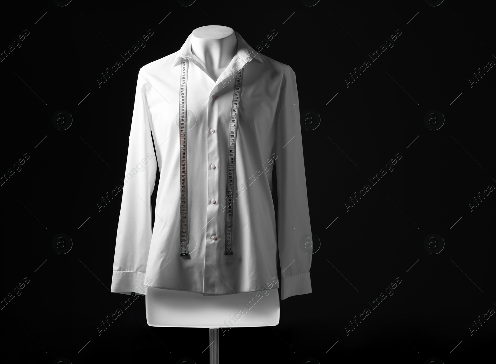 Photo of Male mannequin with white shirt and measuring tape on black background