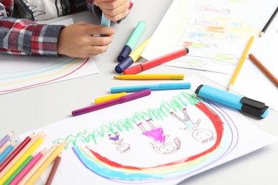 Photo of Boy drawing pictures at light table, closeup