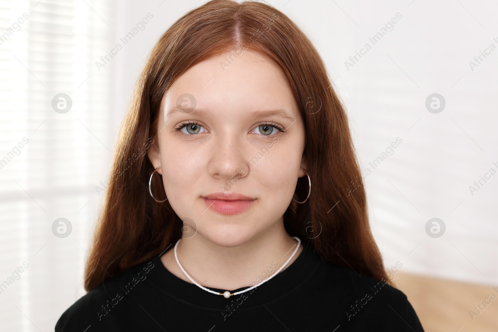 Photo of Portrait of happy teenage girl at home