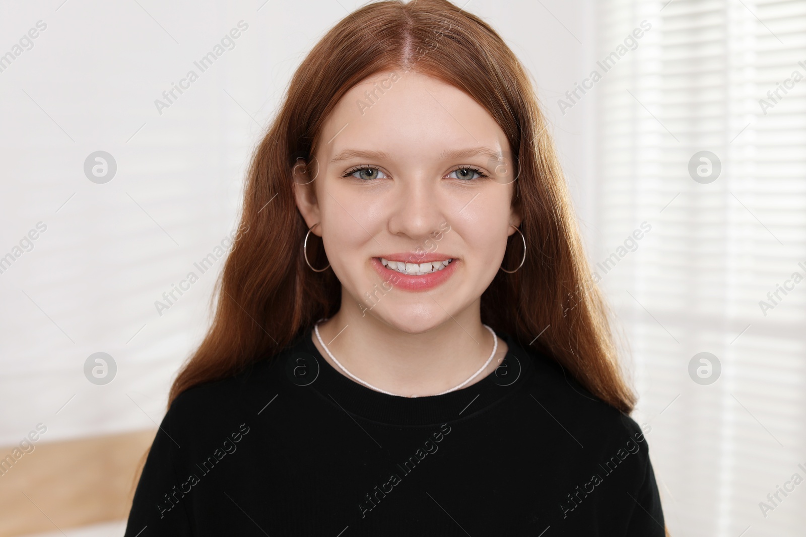 Photo of Portrait of happy teenage girl at home