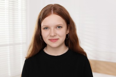 Photo of Portrait of happy teenage girl at home