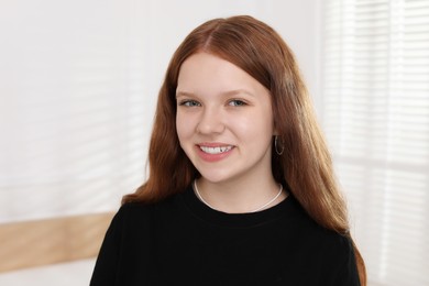 Photo of Portrait of happy teenage girl at home