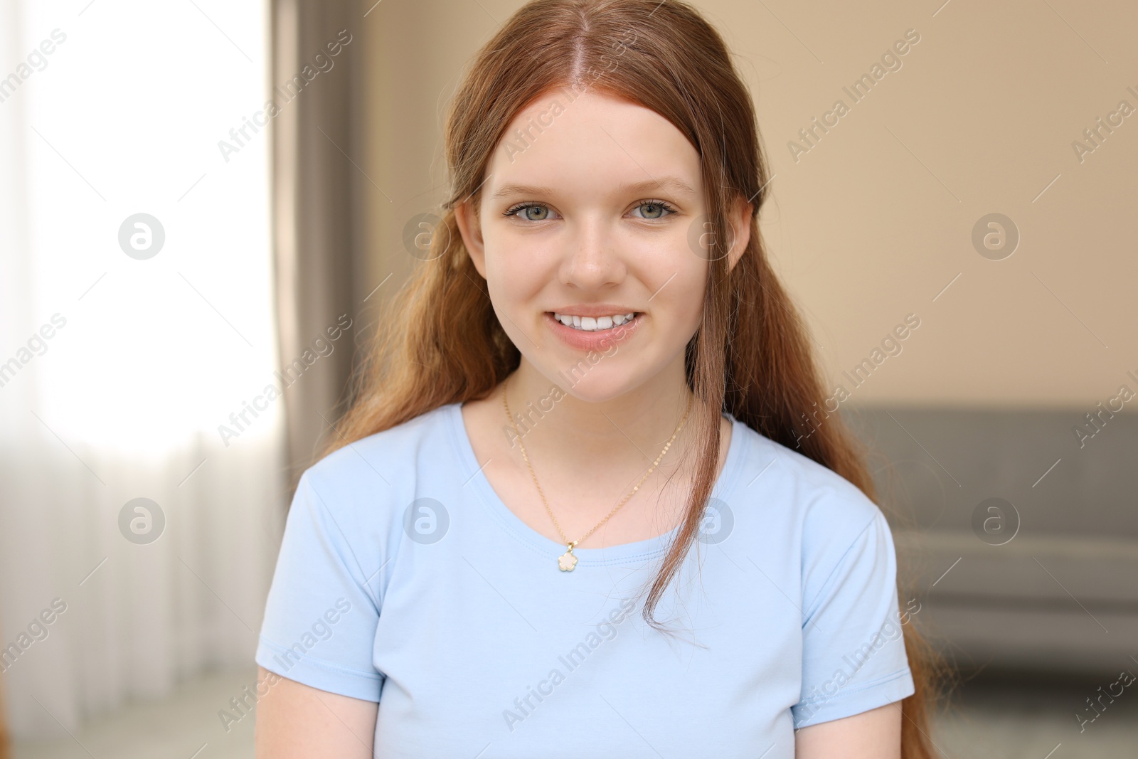 Photo of Portrait of happy teenage girl at home