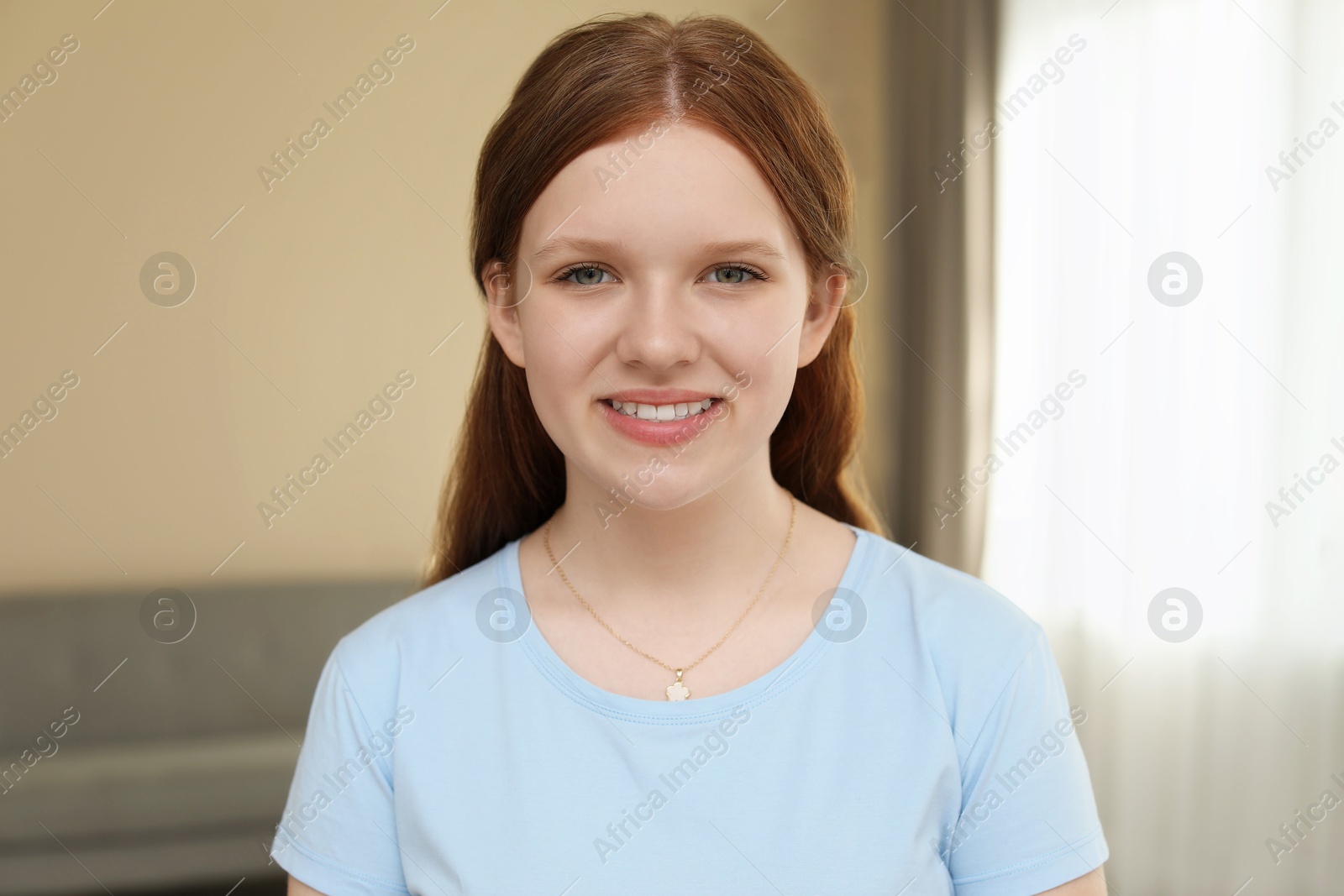 Photo of Portrait of happy teenage girl at home