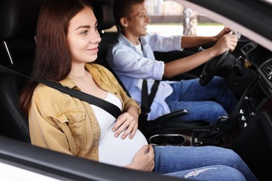 Photo of Pregnant woman travelling with her husband by car