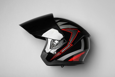 Photo of Modern motorcycle helmet with visor on gray background, top view