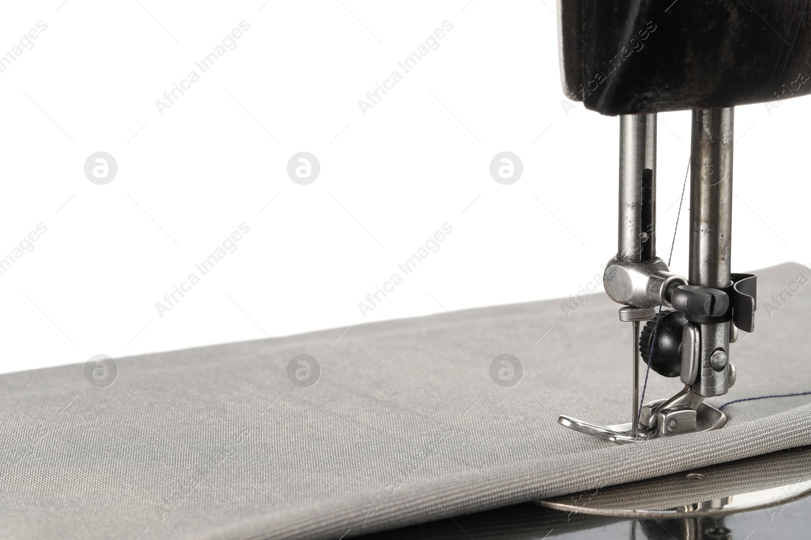 Photo of Sewing machine with grey fabric isolated on white