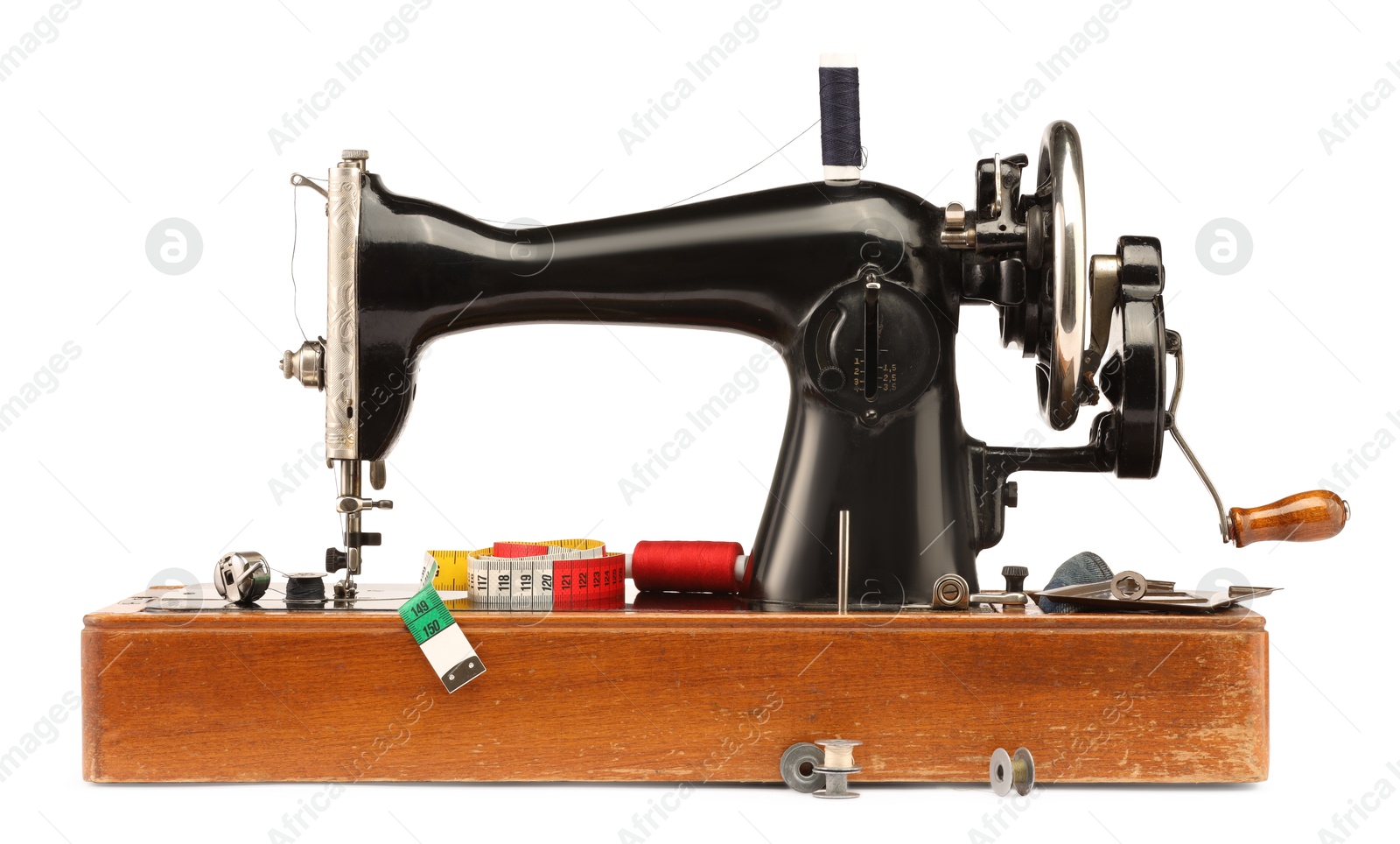 Photo of Sewing machine with measuring tape and spools of threads isolated on white