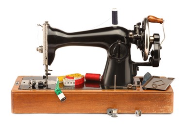 Photo of Sewing machine with measuring tape and spools of threads isolated on white