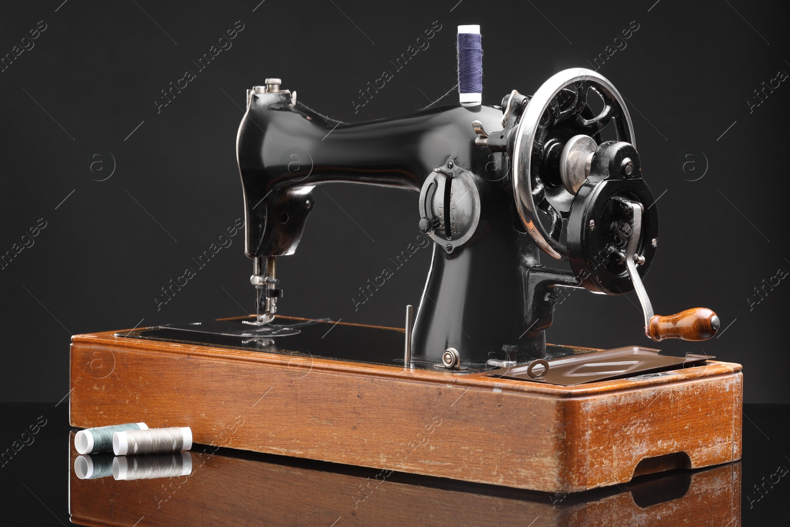 Photo of Vintage professional sewing machine on black background