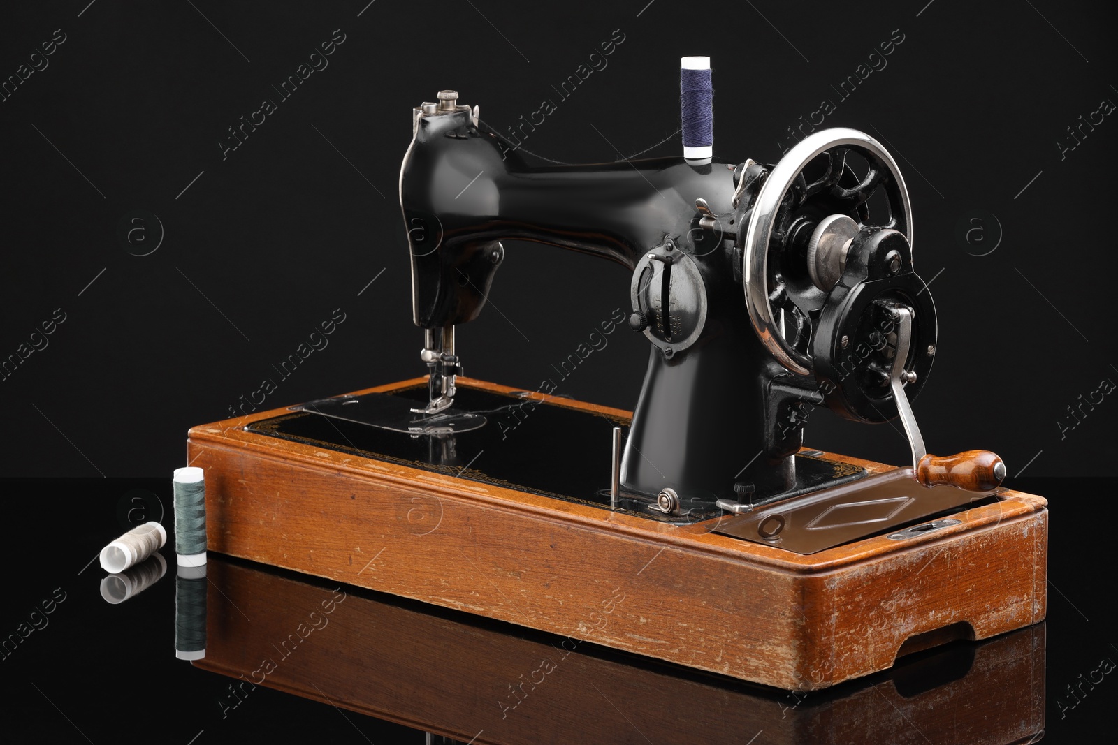 Photo of Vintage professional sewing machine on black background