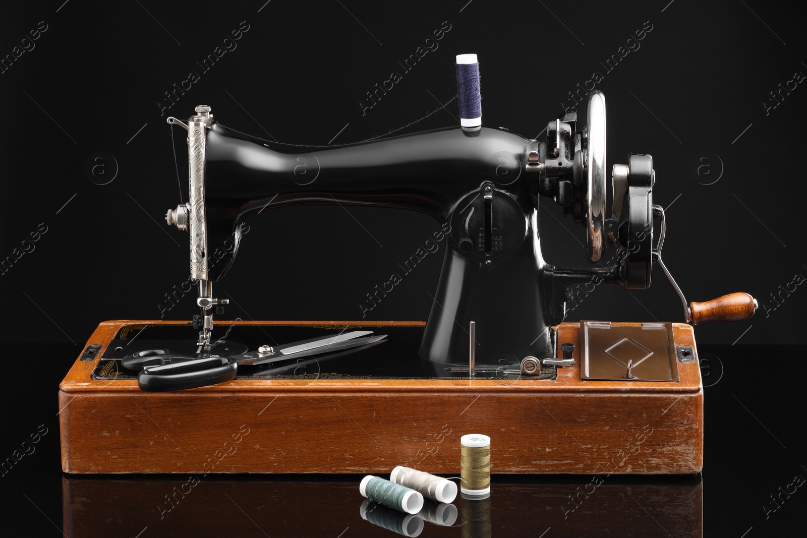 Photo of Vintage professional sewing machine on black background