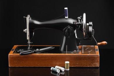 Photo of Vintage professional sewing machine on black background