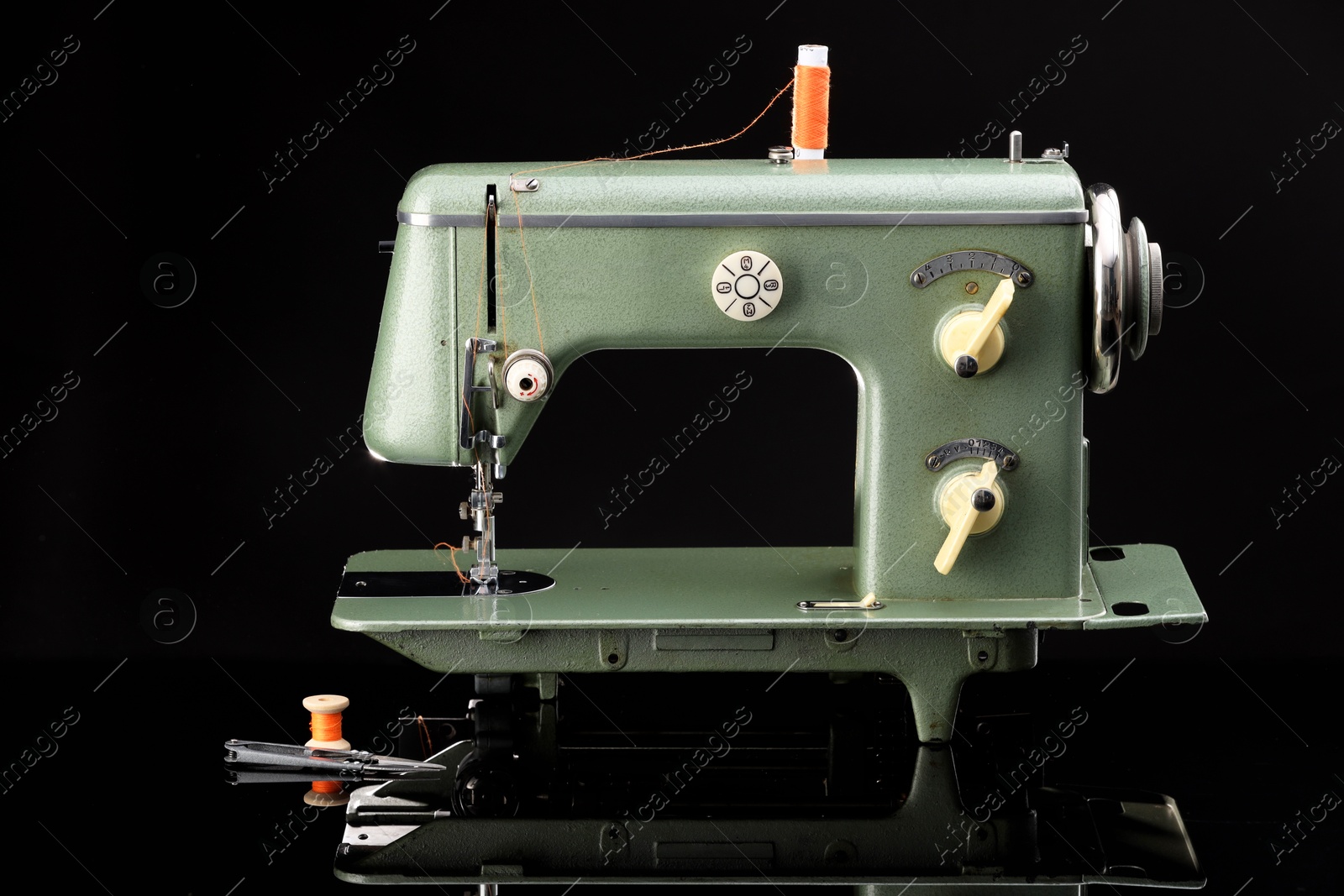 Photo of Vintage professional sewing machine on black background