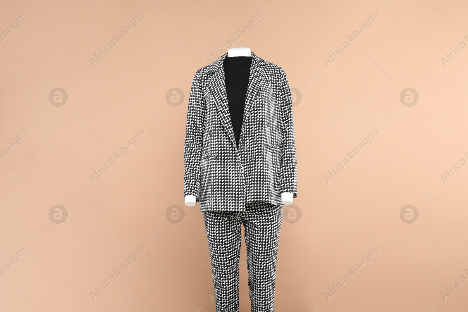 Photo of Female mannequin with stylish outfit on beige background