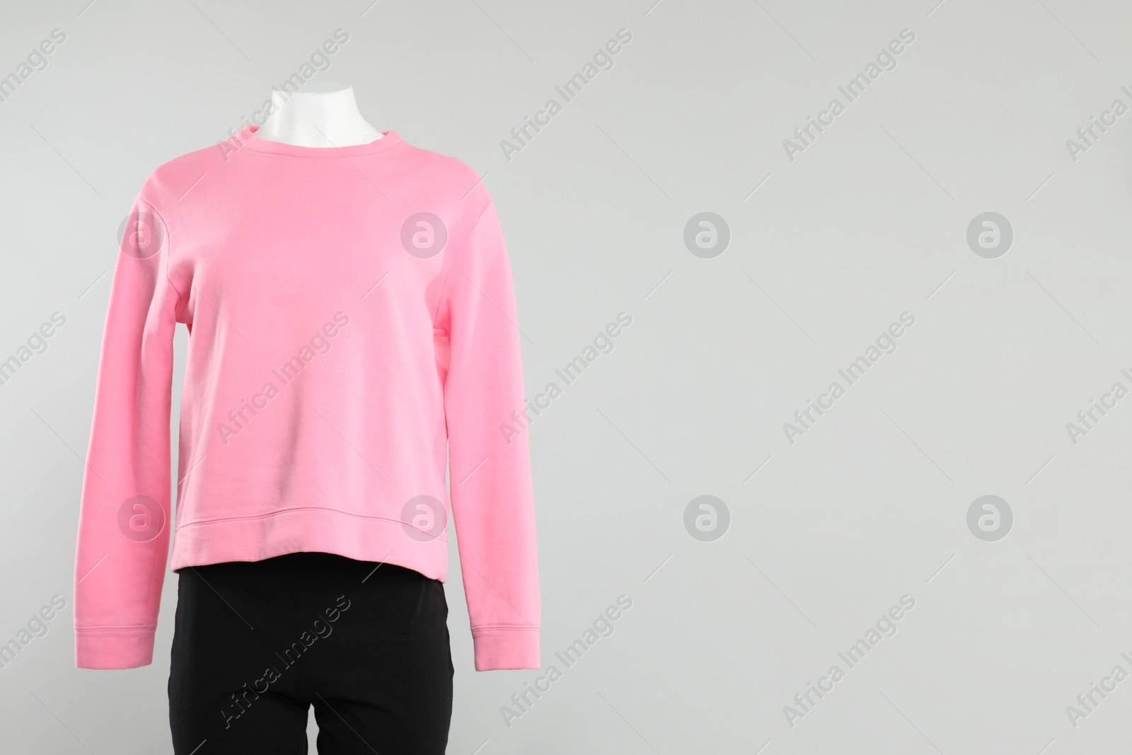 Photo of Female mannequin with stylish outfit on light background, space for text