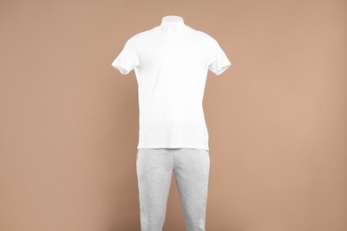 Photo of Male mannequin with stylish sportswear on beige background