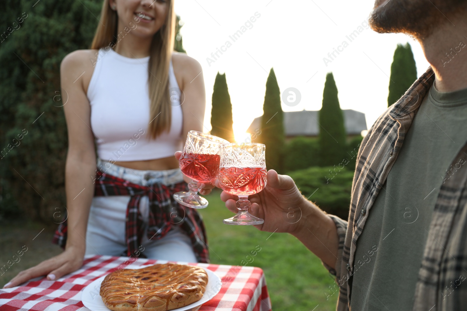 Photo of Couple having romantic date at table in garden, closeup