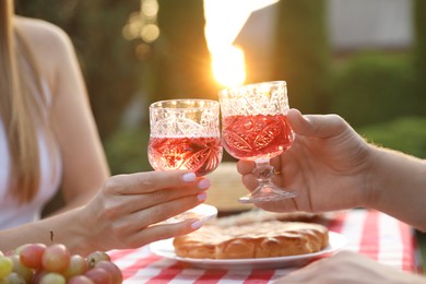 Photo of Couple having romantic date at table in garden, closeup