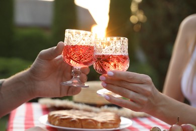 Photo of Couple having romantic date at table in garden, closeup