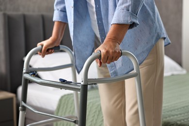 Photo of Senior woman with walking frame at home, closeup