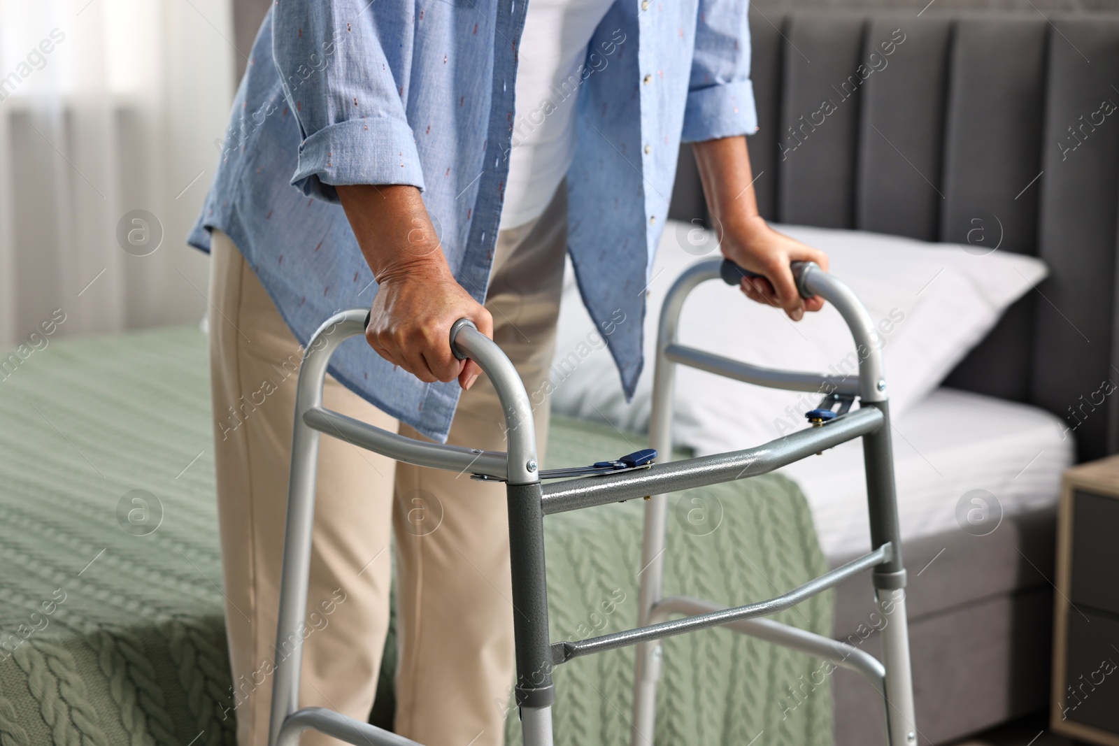 Photo of Senior woman with walking frame at home, closeup