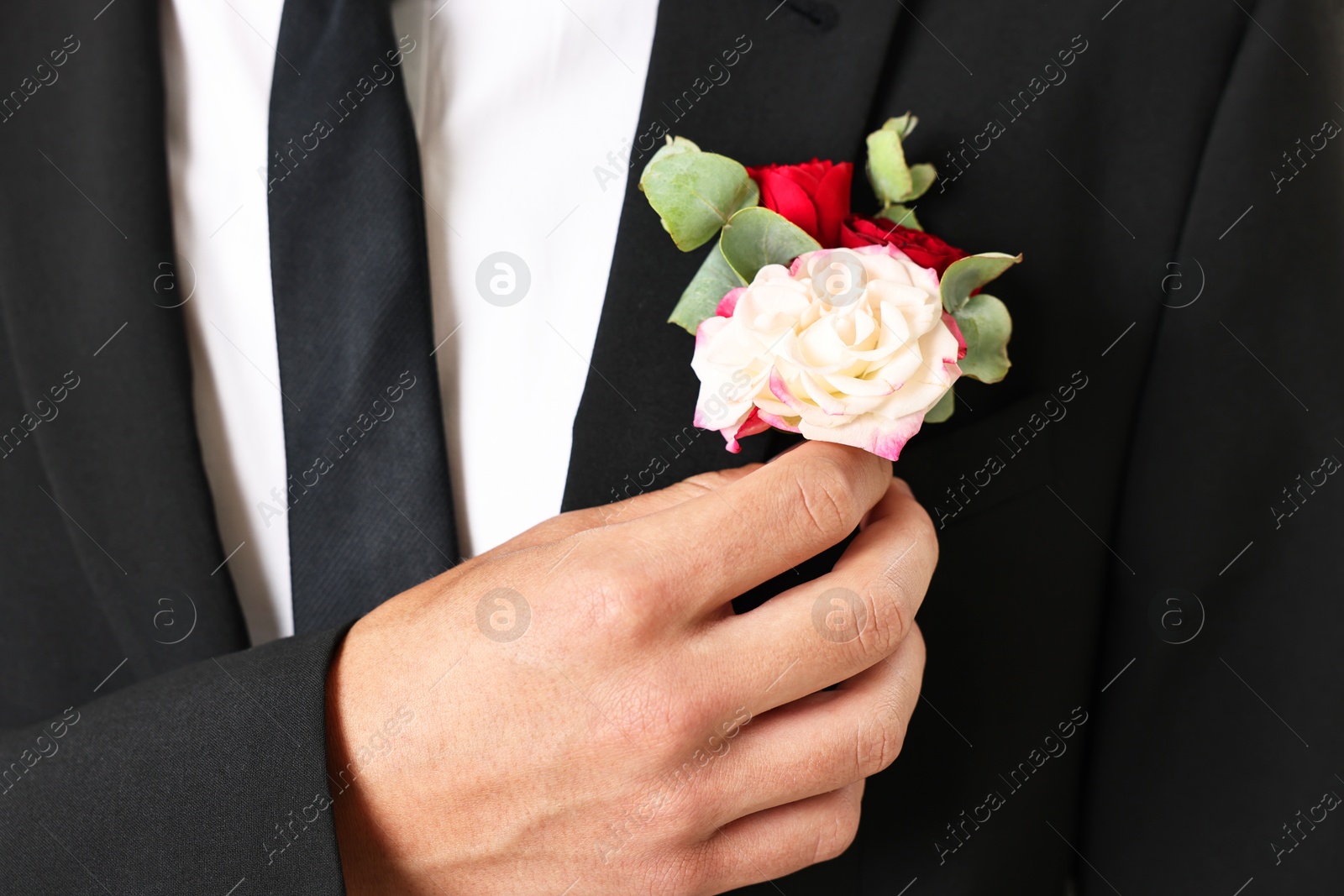 Photo of Groom in suit with stylish boutonniere, closeup