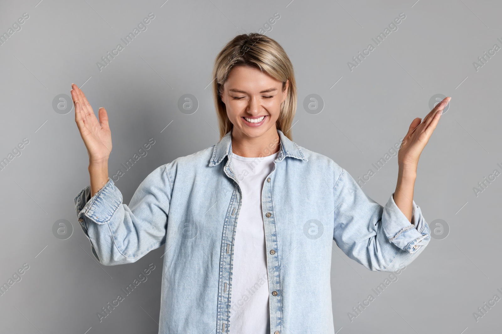 Photo of Portrait of happy winner on gray background