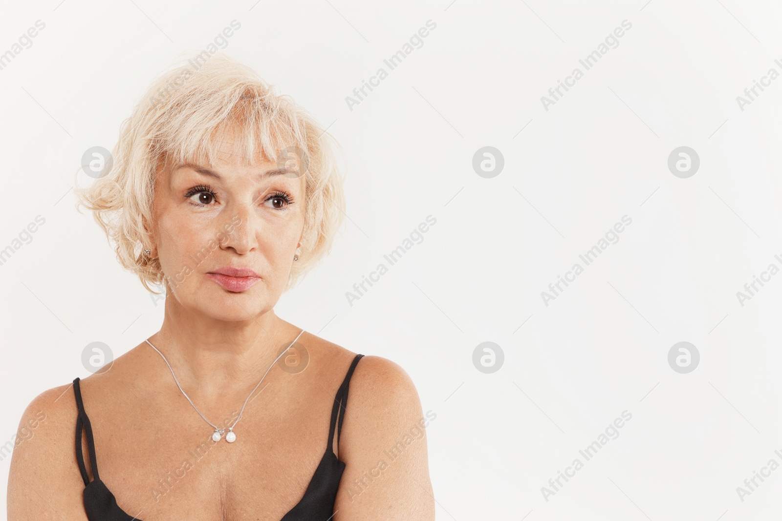 Photo of Portrait of beautiful senior woman on white background, space for text