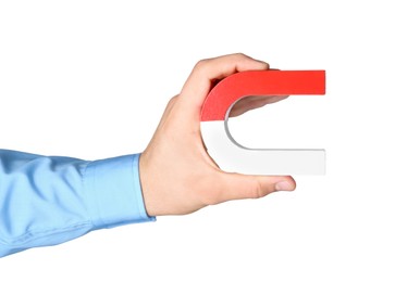 Photo of Man with horseshoe magnet on white background, closeup