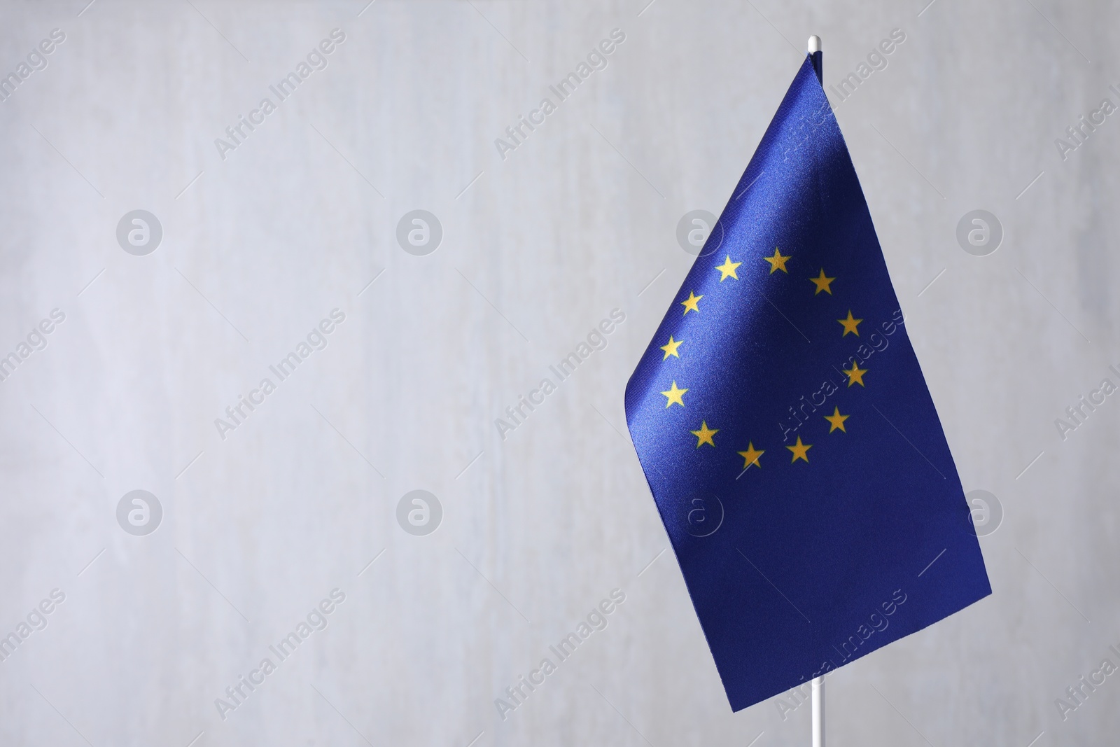 Photo of One flag of European Union on grey textured background. Space for text