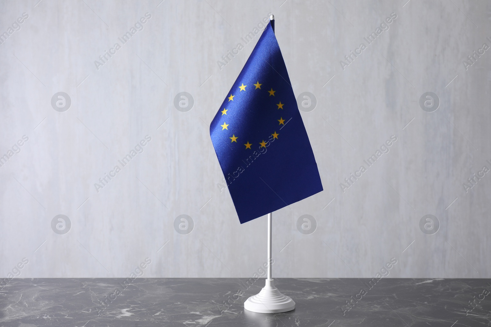 Photo of One flag of European Union on grey marble table