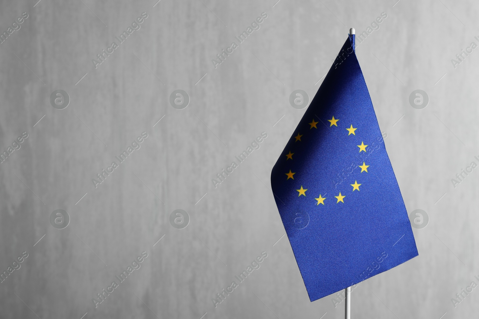 Photo of One flag of European Union on grey textured background. Space for text