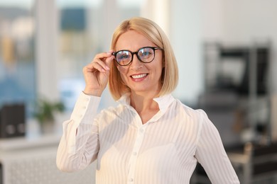 Photo of Portrait of smiling middle aged woman in office