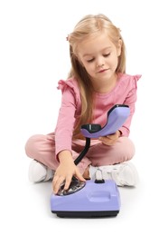 Photo of Cute little girl with telephone on white background