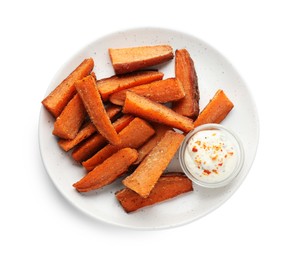 Pieces of tasty baked sweet potato with sauce isolated on white, top view