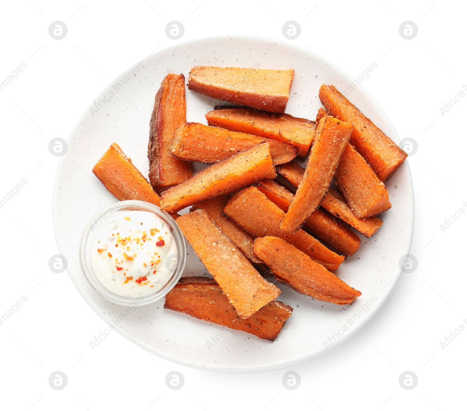 Photo of Pieces of tasty baked sweet potato with sauce isolated on white, top view