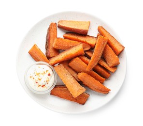 Pieces of tasty baked sweet potato with sauce isolated on white, top view