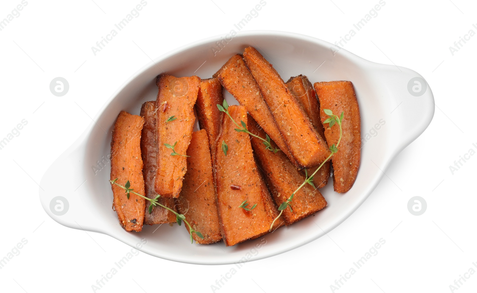 Photo of Pieces of tasty cooked sweet potato with microgreens in baking dish isolated on white, top view