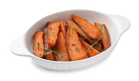 Photo of Pieces of tasty cooked sweet potato with microgreens in baking dish isolated on white