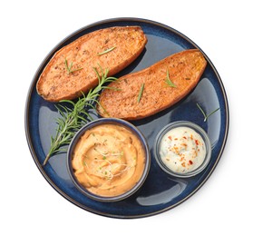 Photo of Halves of tasty baked sweet potato served with sauces isolated on white, top view